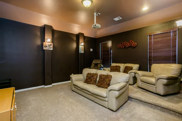 a living room with furniture and a projector screen
