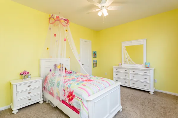 a bedroom with a bed and a dresser
