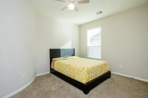 a bedroom with a bed and window