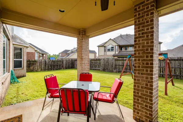 a view of an outdoor sitting area with furniture and wooden floor
