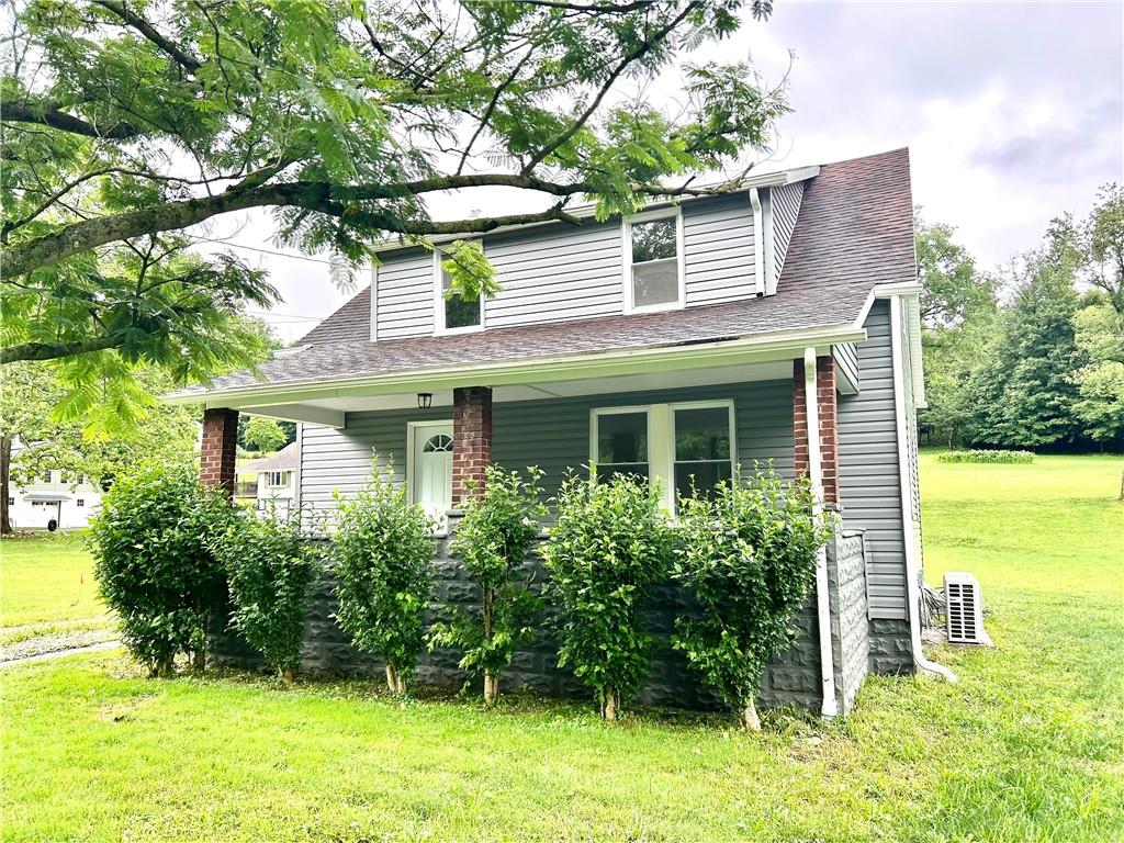718 Breakneck Road Connellsville, PA 15425 - Photo 1 of 30 a front view of a house with garden