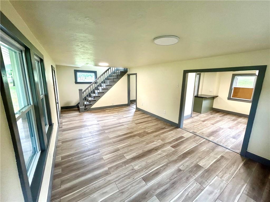 718 Breakneck Road Connellsville, PA 15425 - Photo 8 of 30 a view of a hallway to a livingroom with wooden floor and stairs