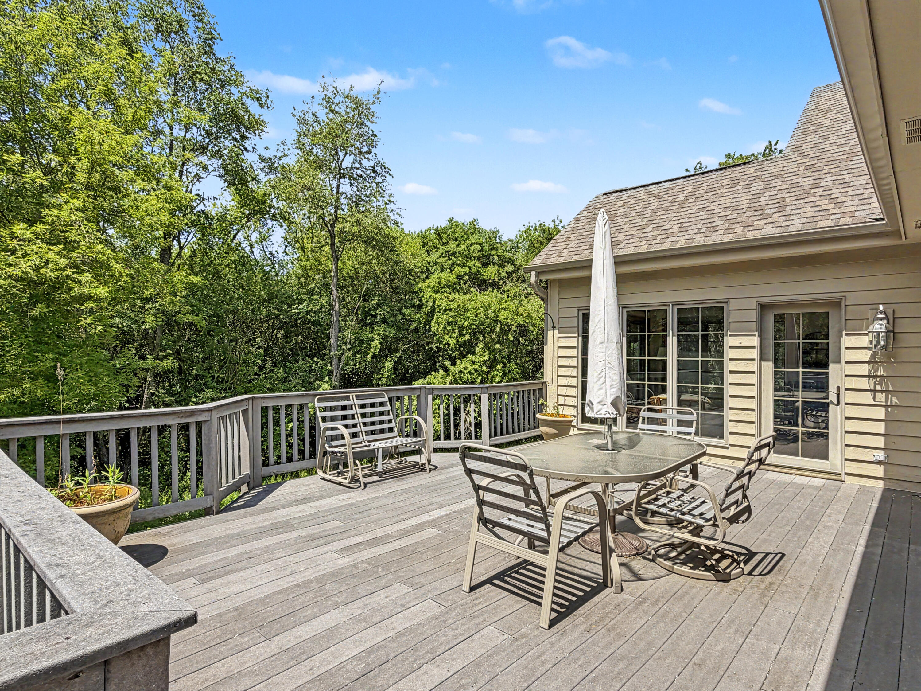 W291-s5245 Ridgefield Road Waukesha, WI 53189 - Photo 8 of 44 Spacious 32’ x 16’ composite deck just off the sunroom, overlooking the private wooded setting.
