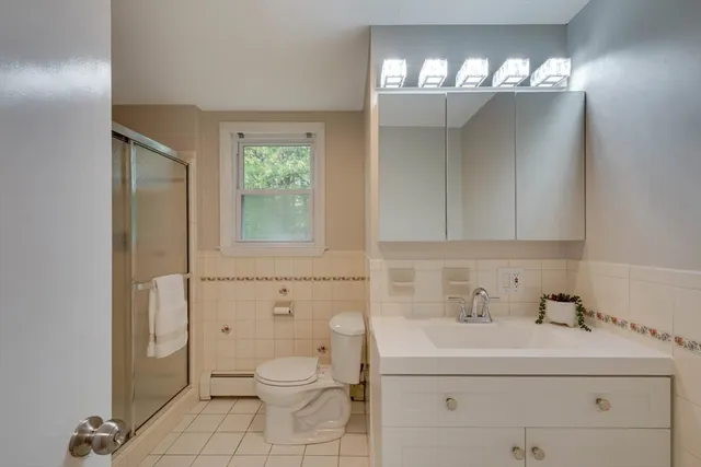 a bathroom with a sink a toilet and mirror