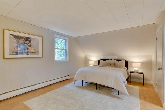 a bedroom with a bed and a lamp