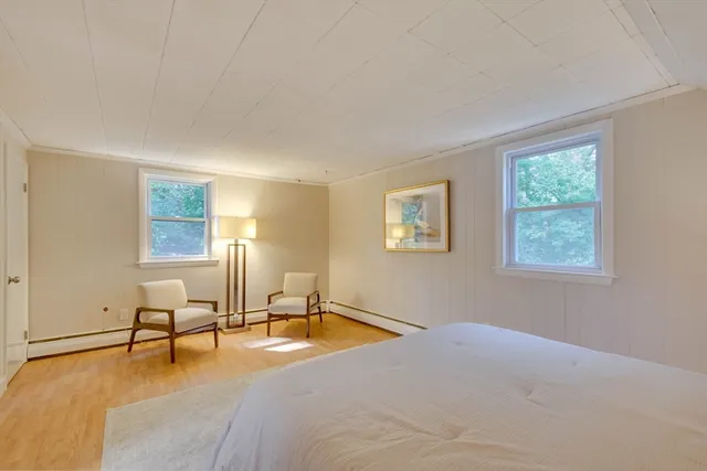 a room with a bed furniture and a window