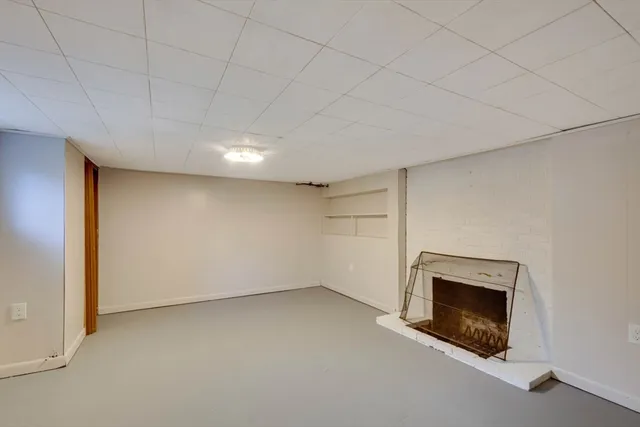 a view of an empty room with a fireplace