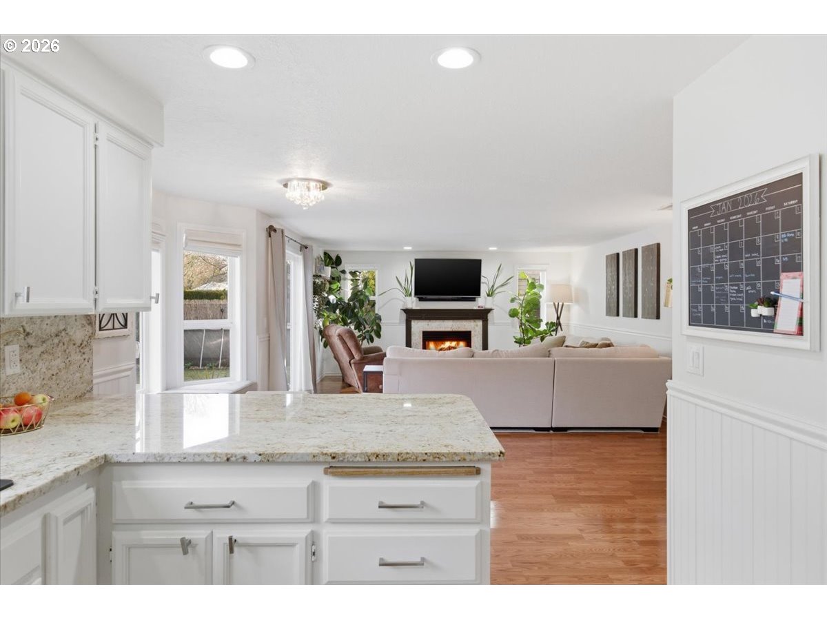 229 Hazelbrook Drive North Keizer, OR 97303 - Photo 14 of 48 a kitchen with kitchen island granite countertop a stove a sink and a granite counter tops with white cabinets
