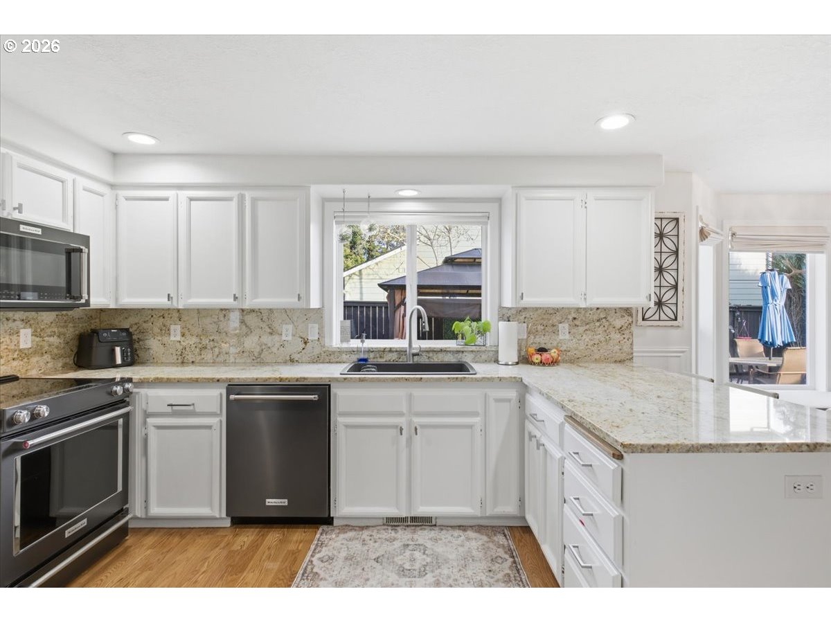 229 Hazelbrook Drive North Keizer, OR 97303 - Photo 17 of 48 a kitchen with a sink stove and cabinets