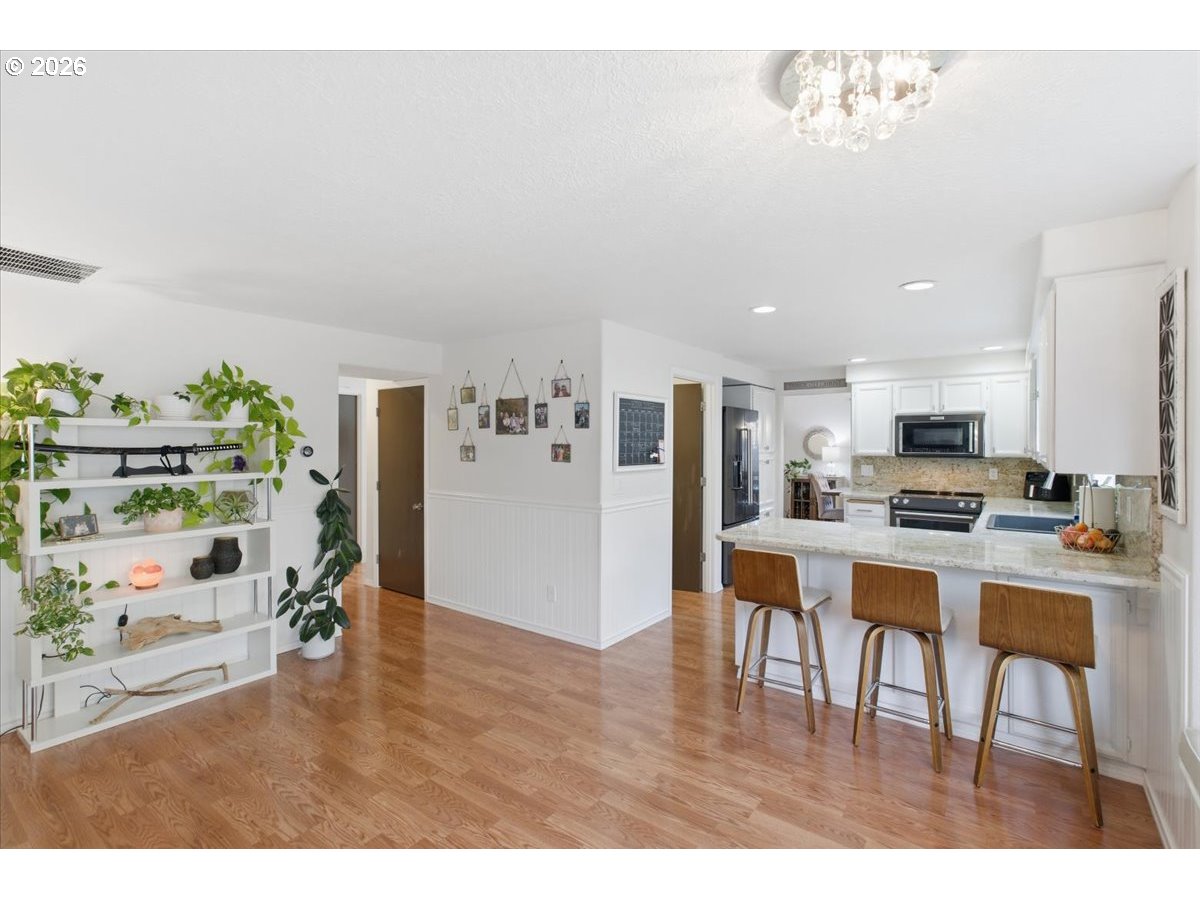 229 Hazelbrook Drive North Keizer, OR 97303 - Photo 21 of 48 a living room with furniture and a dining table with kitchen view