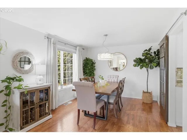 a view of a dining room with furniture and chandelier