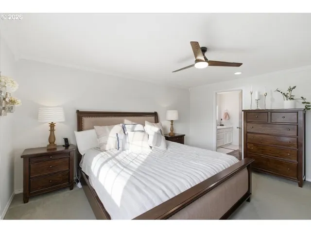 a bedroom with a bed and a night stand