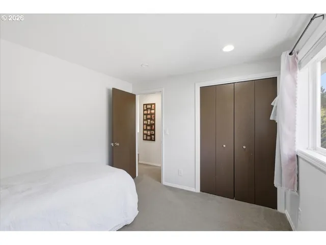 a bedroom with a bed and a mirror