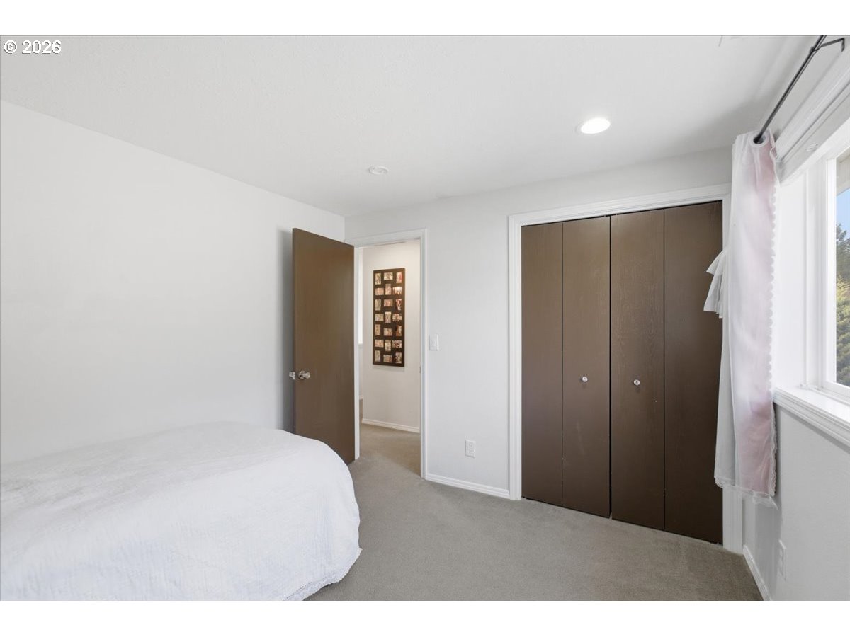 229 Hazelbrook Drive North Keizer, OR 97303 - Photo 36 of 48 a bedroom with a bed and a mirror