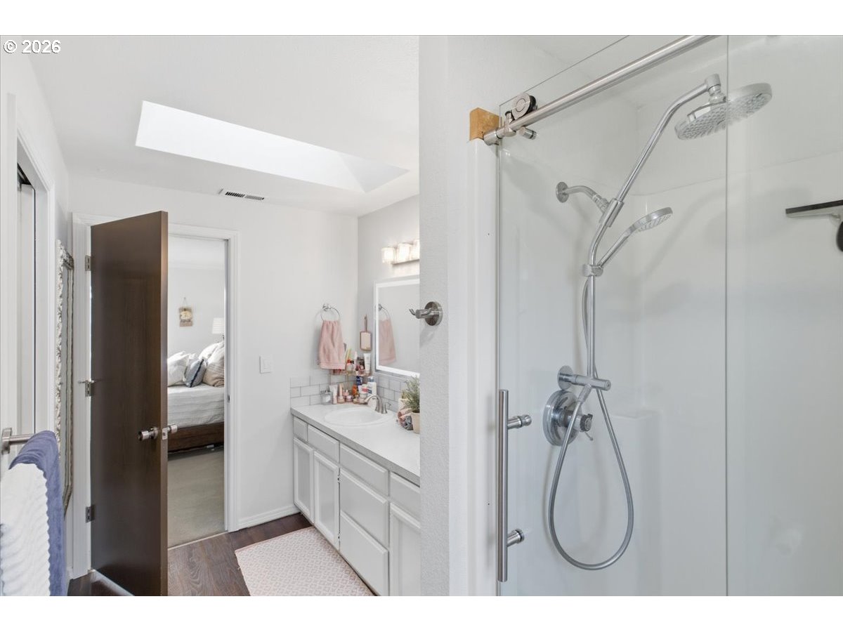 229 Hazelbrook Drive North Keizer, OR 97303 - Photo 42 of 48 a en suite bathroom with a granite countertop sink a mirror and a shower