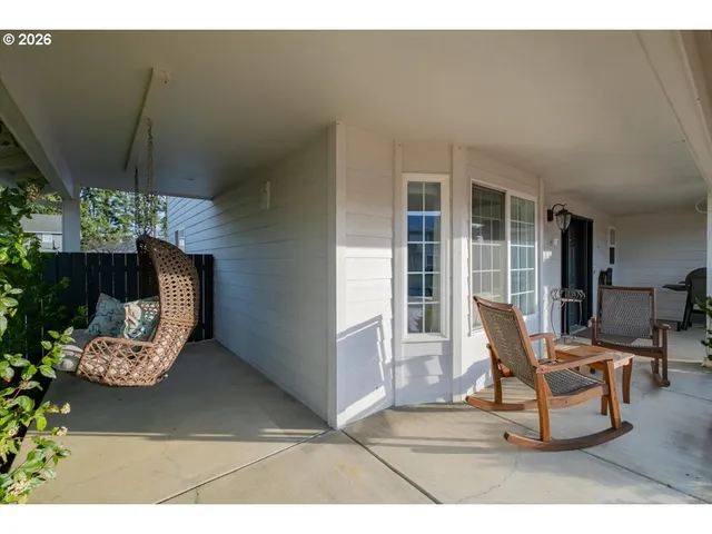 a building outdoor space with patio furniture and potted plants