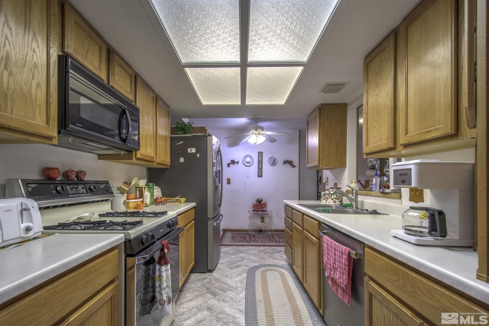2626 Rice Road Fallon, NV 89406 - Photo 14 of 39 a kitchen with stainless steel appliances granite countertop a sink stove and cabinets