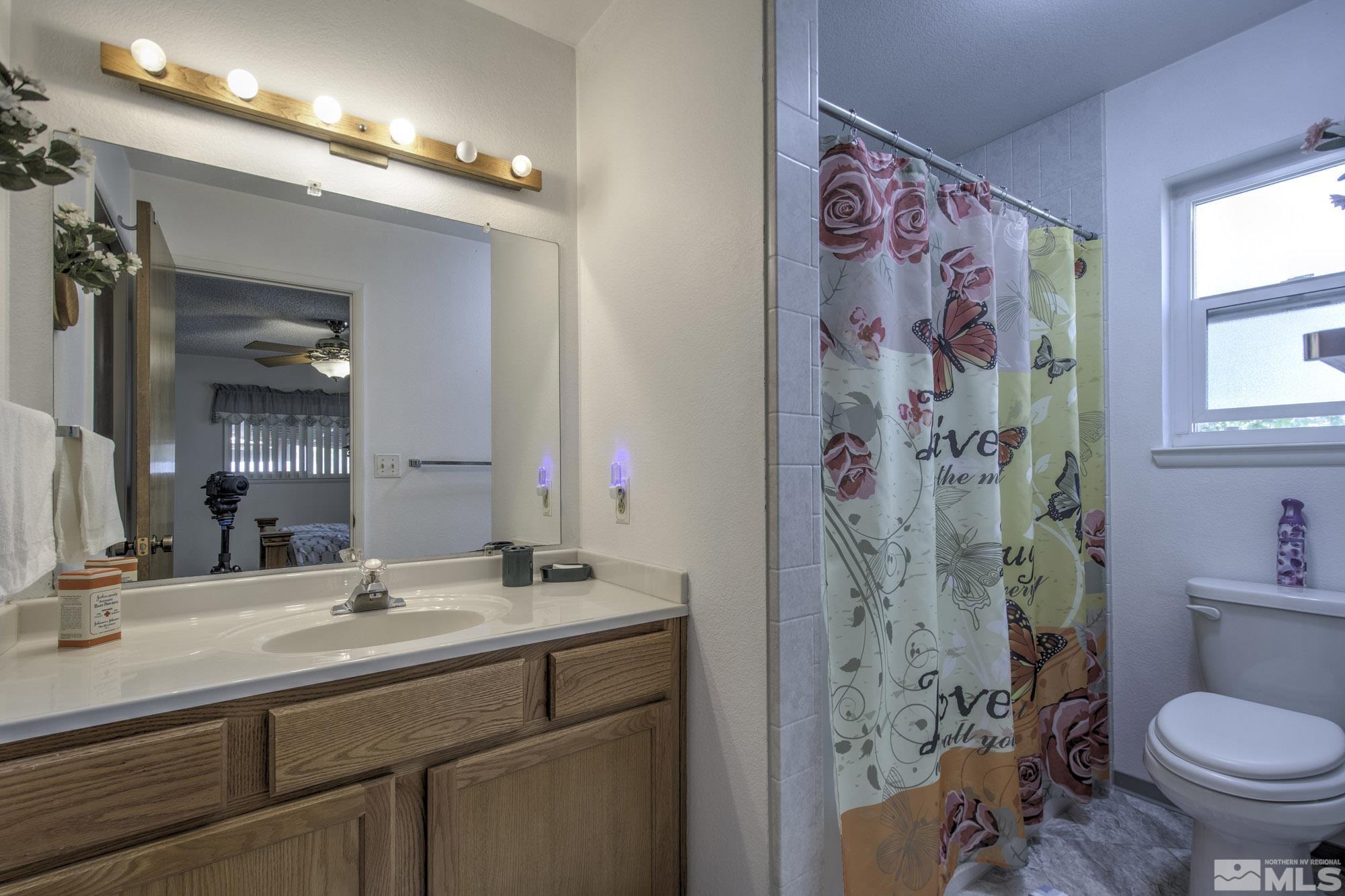 2626 Rice Road Fallon, NV 89406 - Photo 21 of 39 a bathroom with a sink toilet and shower curtain