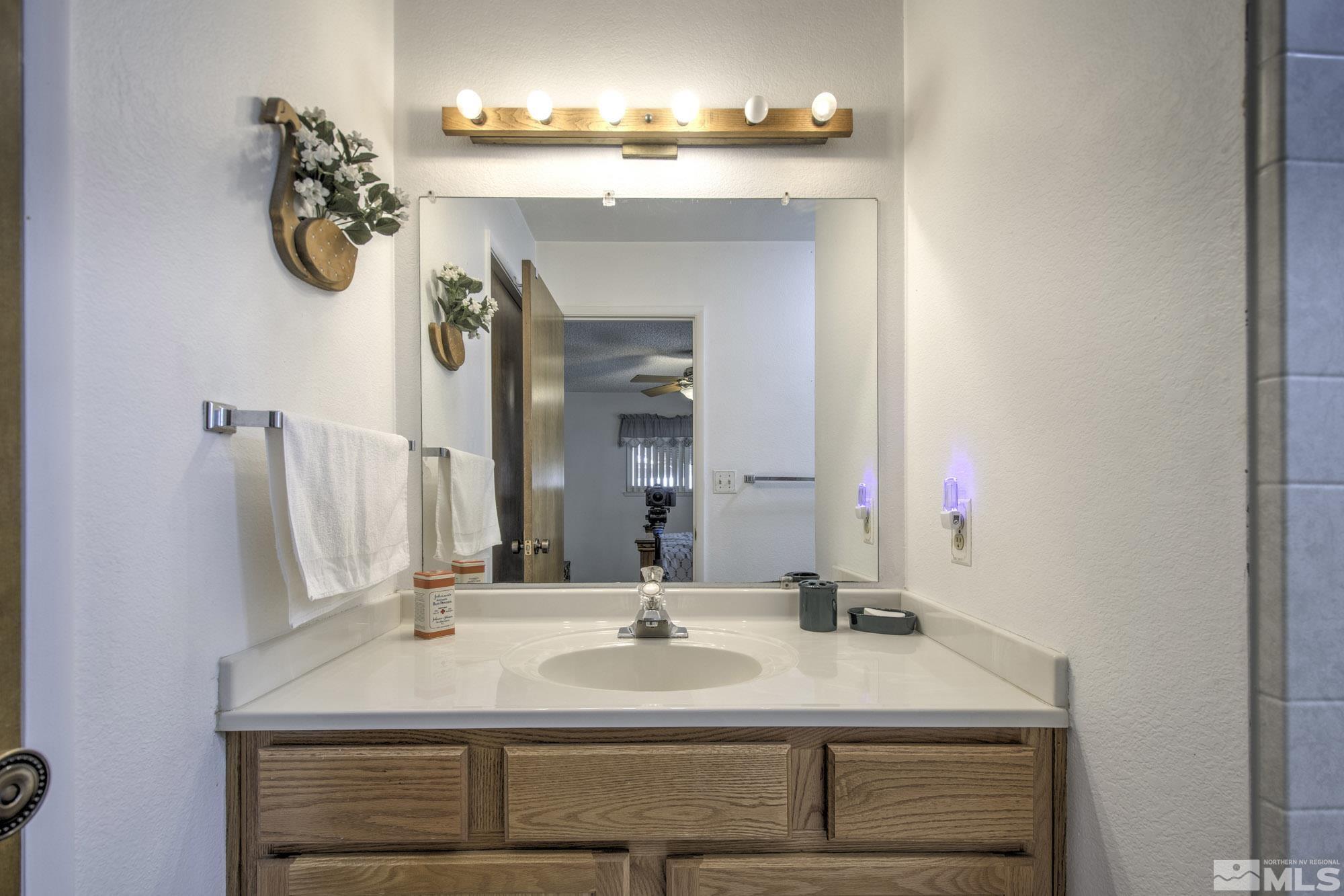 2626 Rice Road Fallon, NV 89406 - Photo 23 of 39 a bathroom with a sink vanity and a mirror