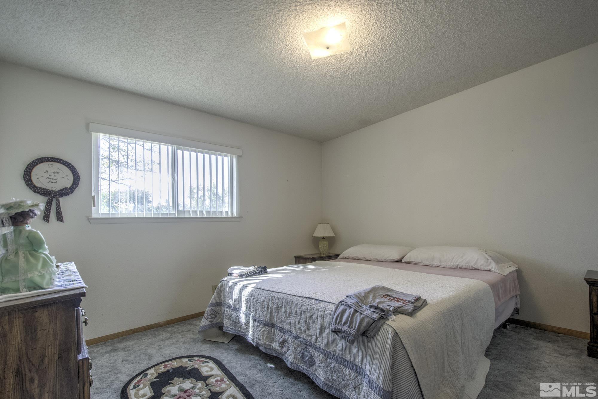 2626 Rice Road Fallon, NV 89406 - Photo 24 of 39 a bedroom with a bed and a window