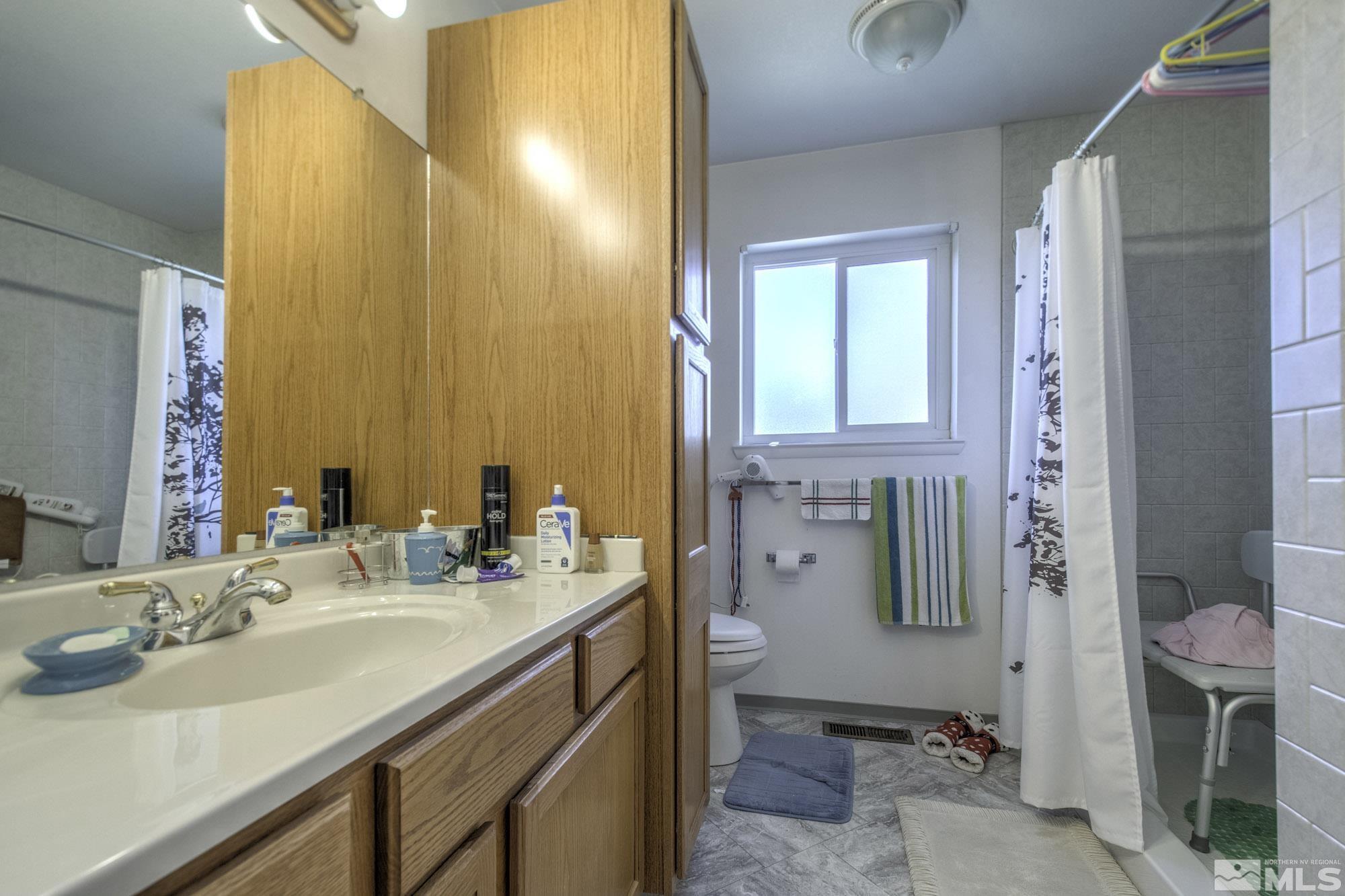 2626 Rice Road Fallon, NV 89406 - Photo 25 of 39 a bathroom with a sink vanity granite and a mirror