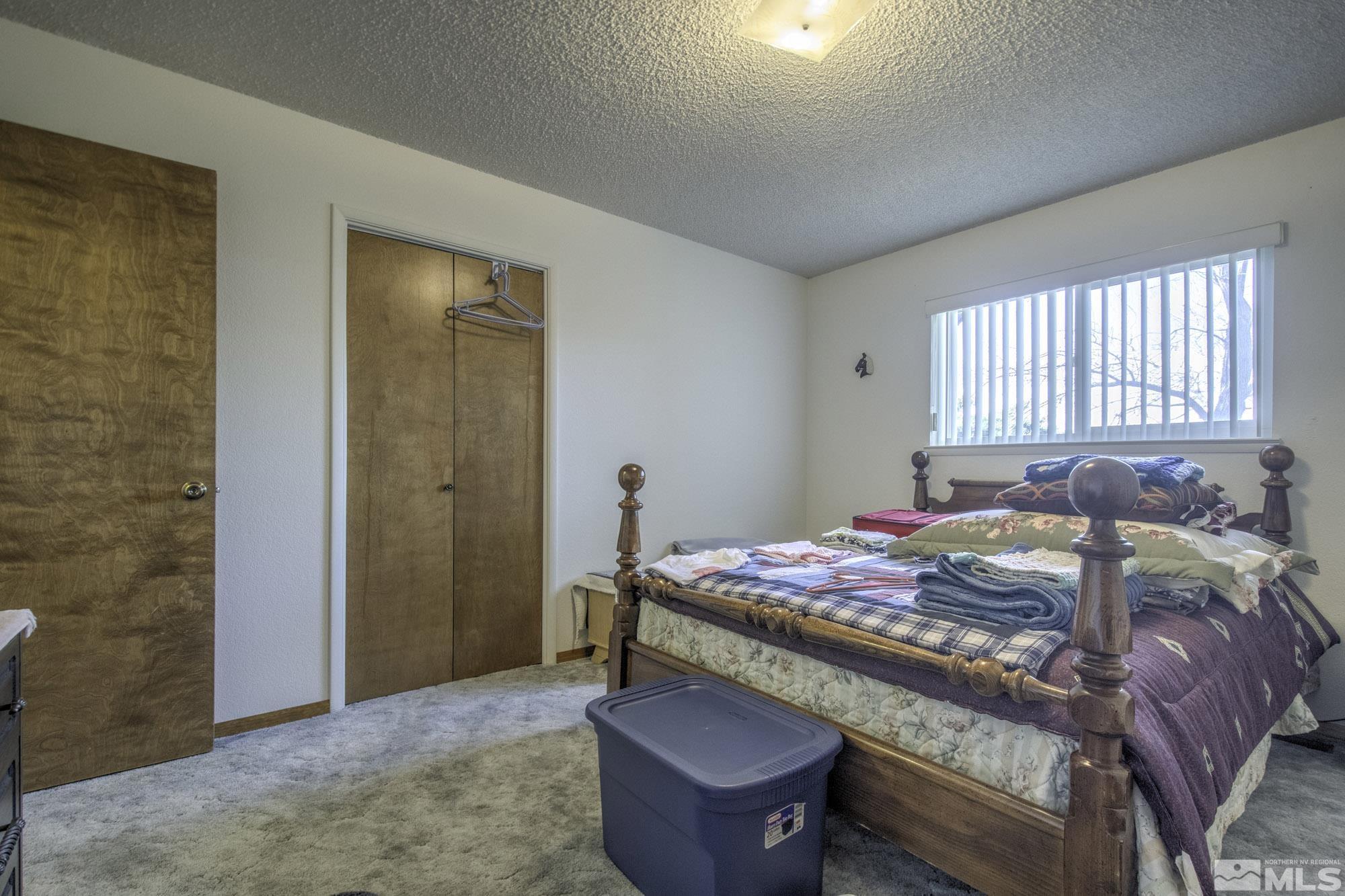 2626 Rice Road Fallon, NV 89406 - Photo 26 of 39 a bed sitting in a bedroom next to a window