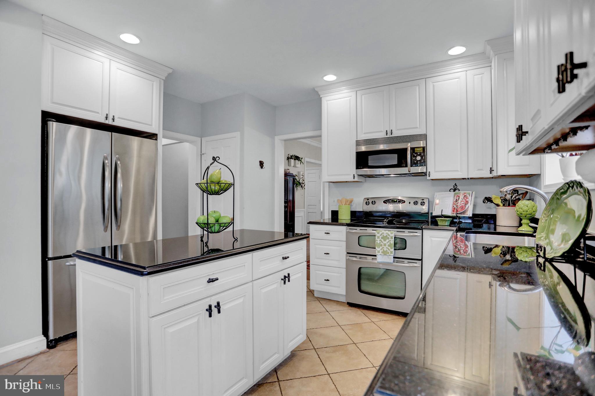 121 Croydon Road Baltimore, MD 21212 - Photo 8 of 57 a kitchen with stainless steel appliances kitchen island granite countertop a refrigerator a stove top oven a sink and cabinets