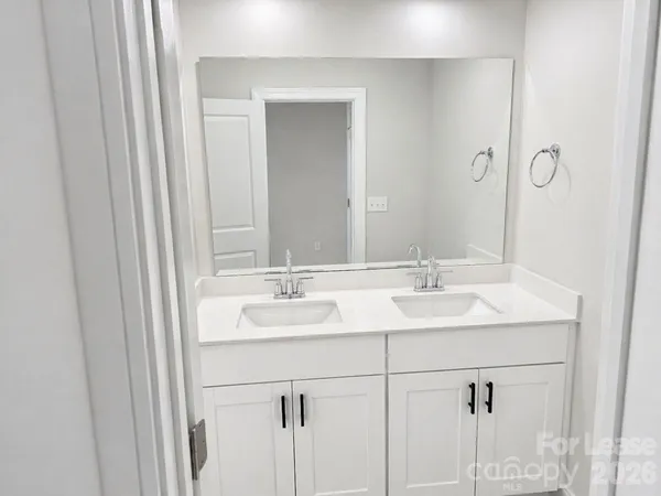 a bathroom with 2 sink and a mirror