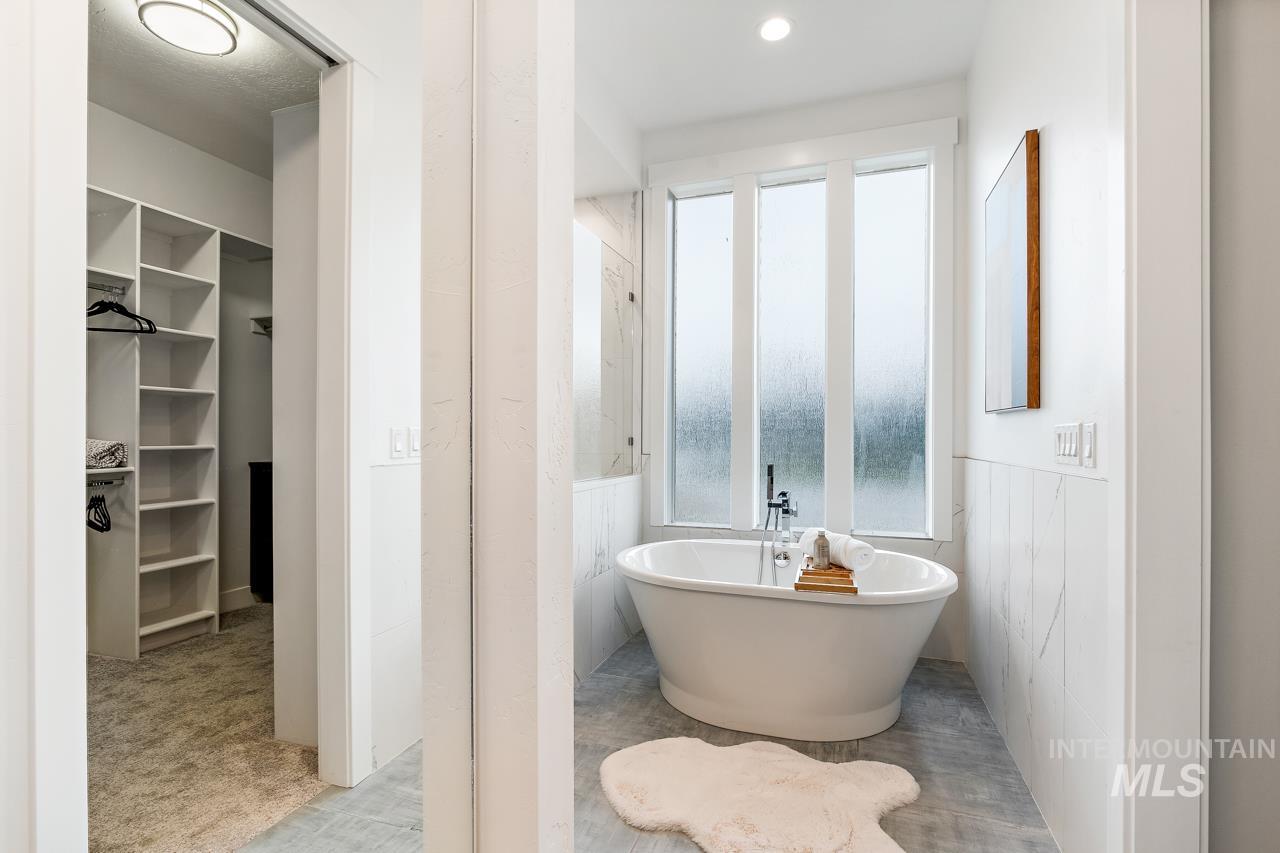 599 West Warren Street Boise, ID 83706 - Photo 20 of 41 Freestanding soaking tub with a floor-mounted faucet set against a privacy window