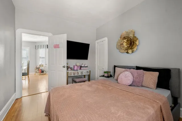 a bedroom with a bed and a flat screen tv