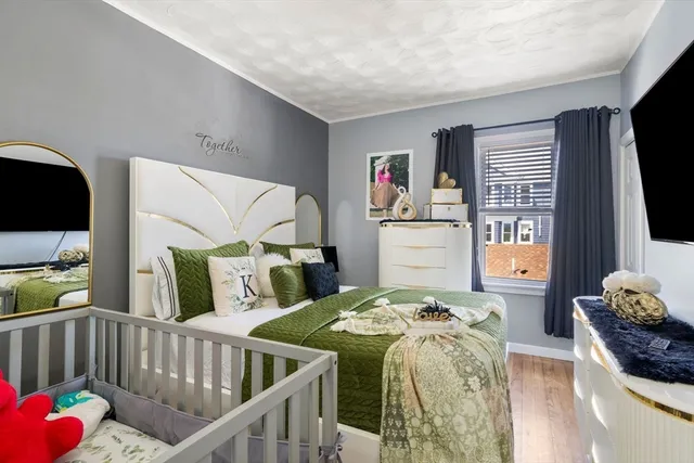 a bedroom with furniture and a flat screen tv