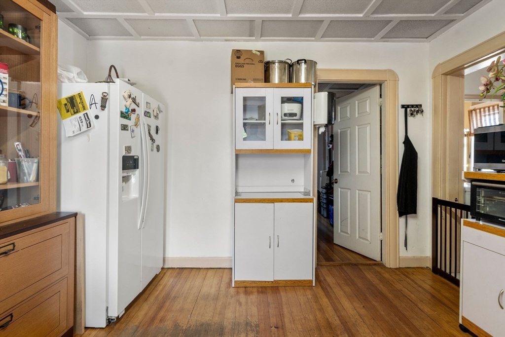 248-250 Jefferson Street Fall River, MA 02721 - Photo 20 of 37 a view of a kitchen with fridge and wooden floor