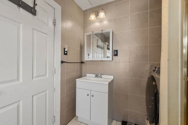 a bathroom with a sink mirror and toilet