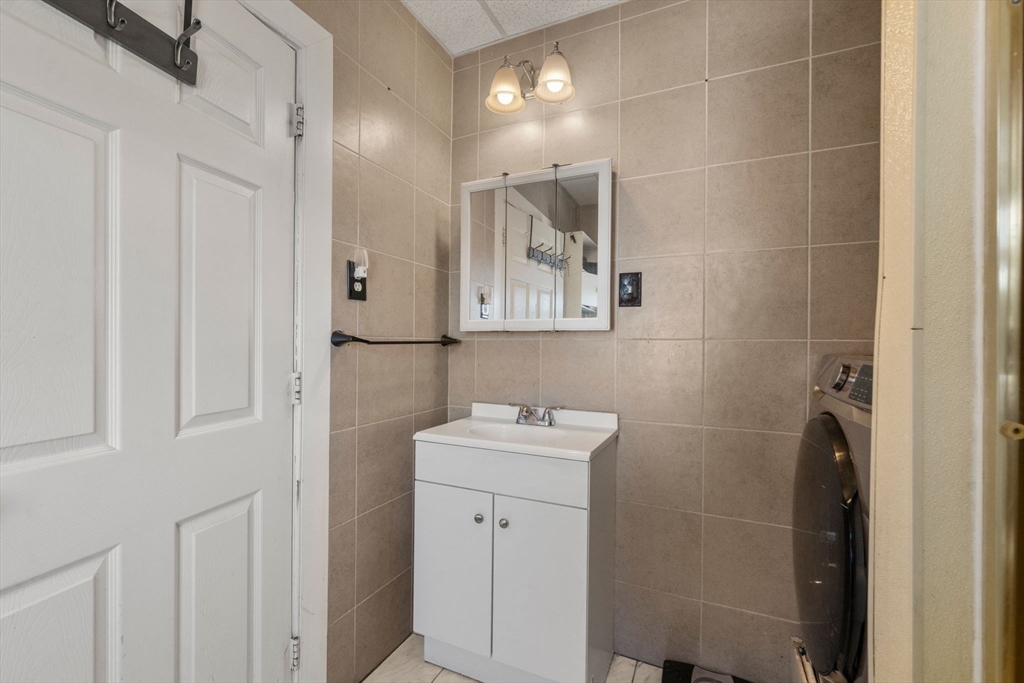 248-250 Jefferson Street Fall River, MA 02721 - Photo 22 of 37 a bathroom with a sink mirror and toilet