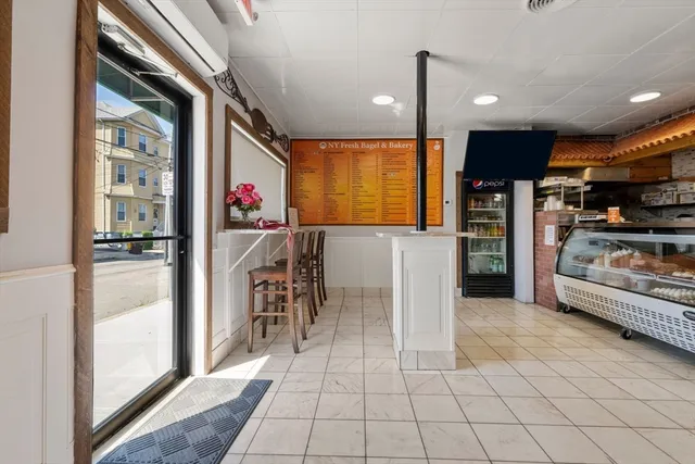 a view of a kitchen with furniture and a refrigerator
