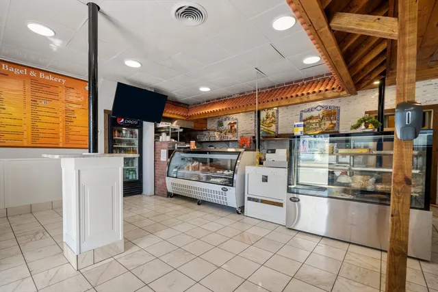 a kitchen with stainless steel appliances kitchen island granite countertop a refrigerator and a stove top oven