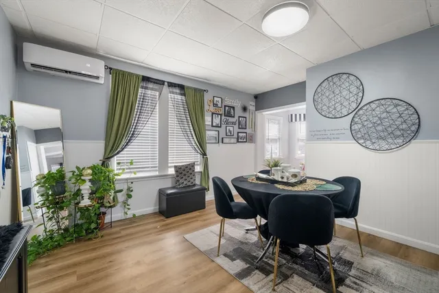 a dining room with furniture and window
