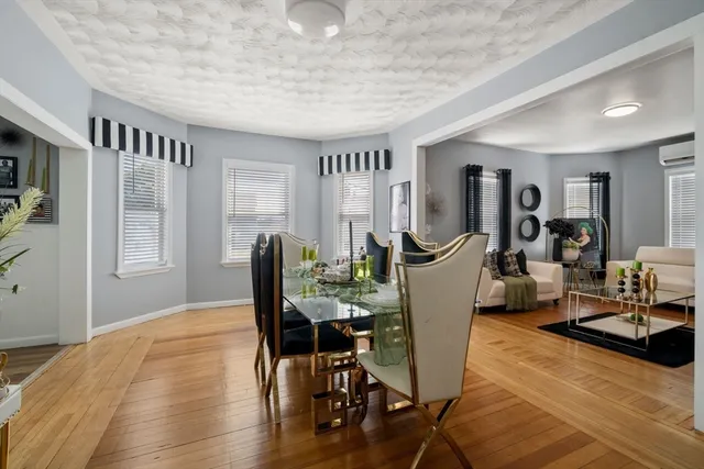 a view of a dining room with furniture window and wooden floor