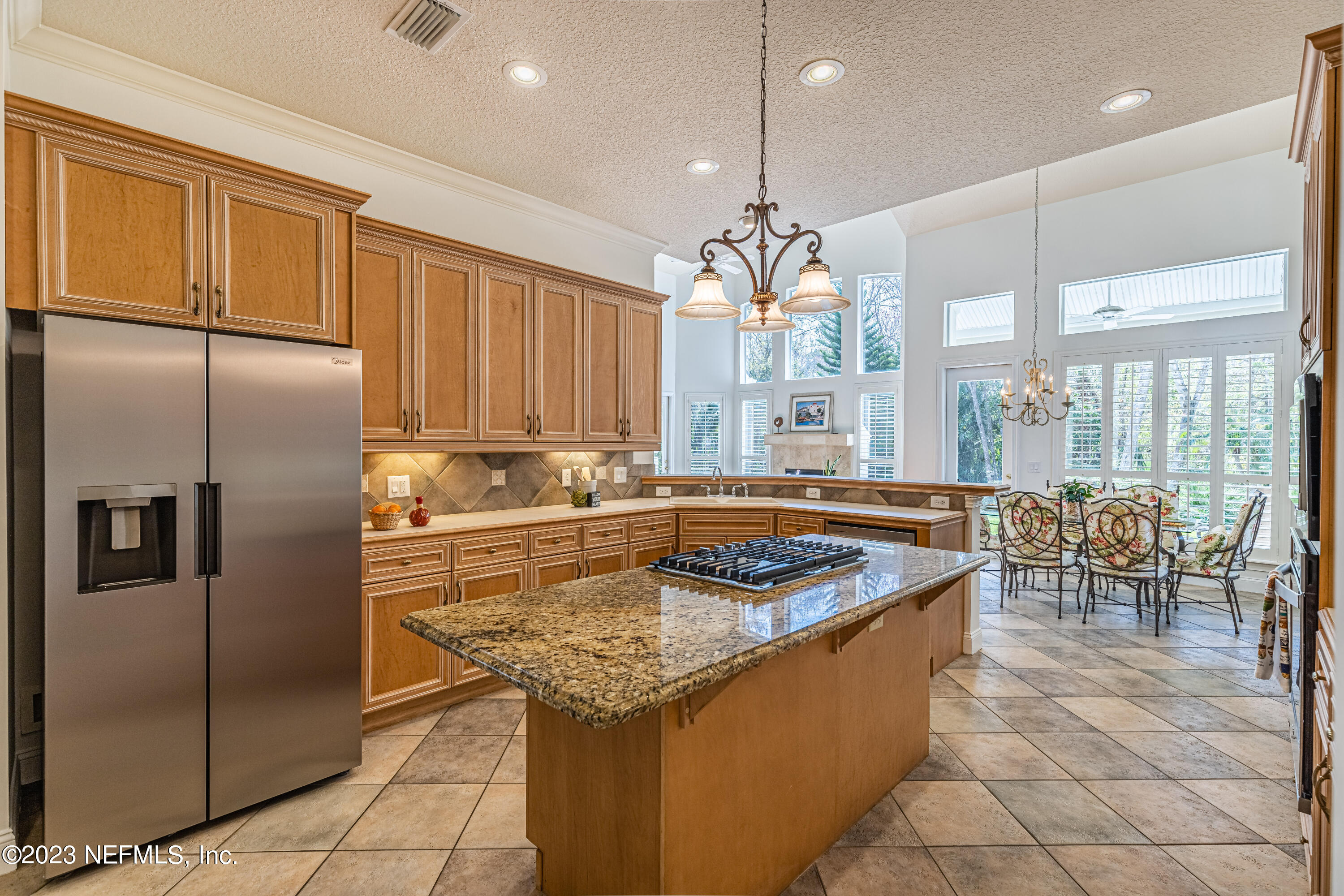 513 Fresh Pond Road Ponte Vedra Beach, FL 32082 - Photo 35 of 58 a kitchen with stainless steel appliances granite countertop a sink a counter and a refrigerator