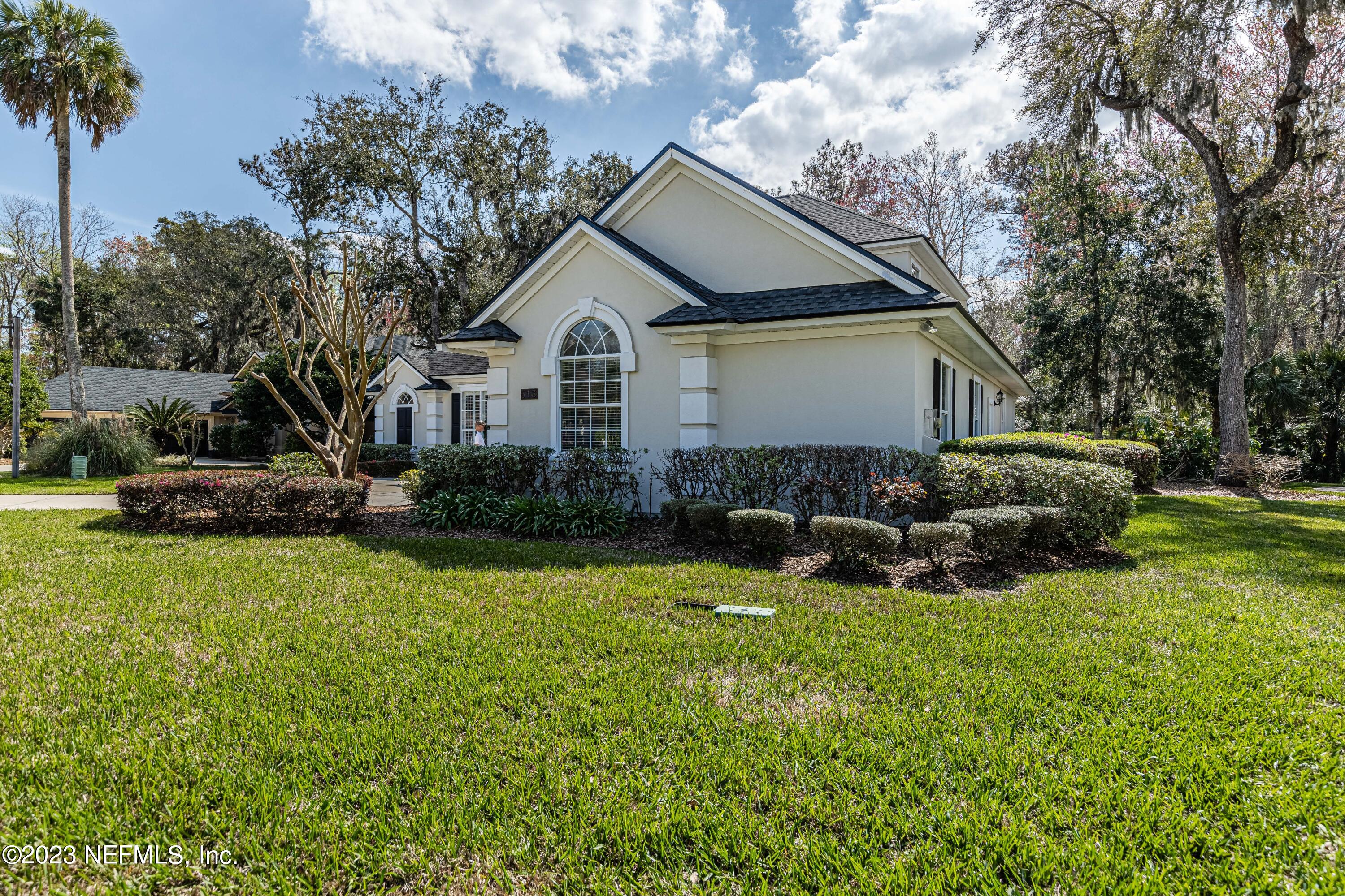 513 Fresh Pond Road Ponte Vedra Beach, FL 32082 - Photo 47 of 58 a front view of a house with a garden and trees