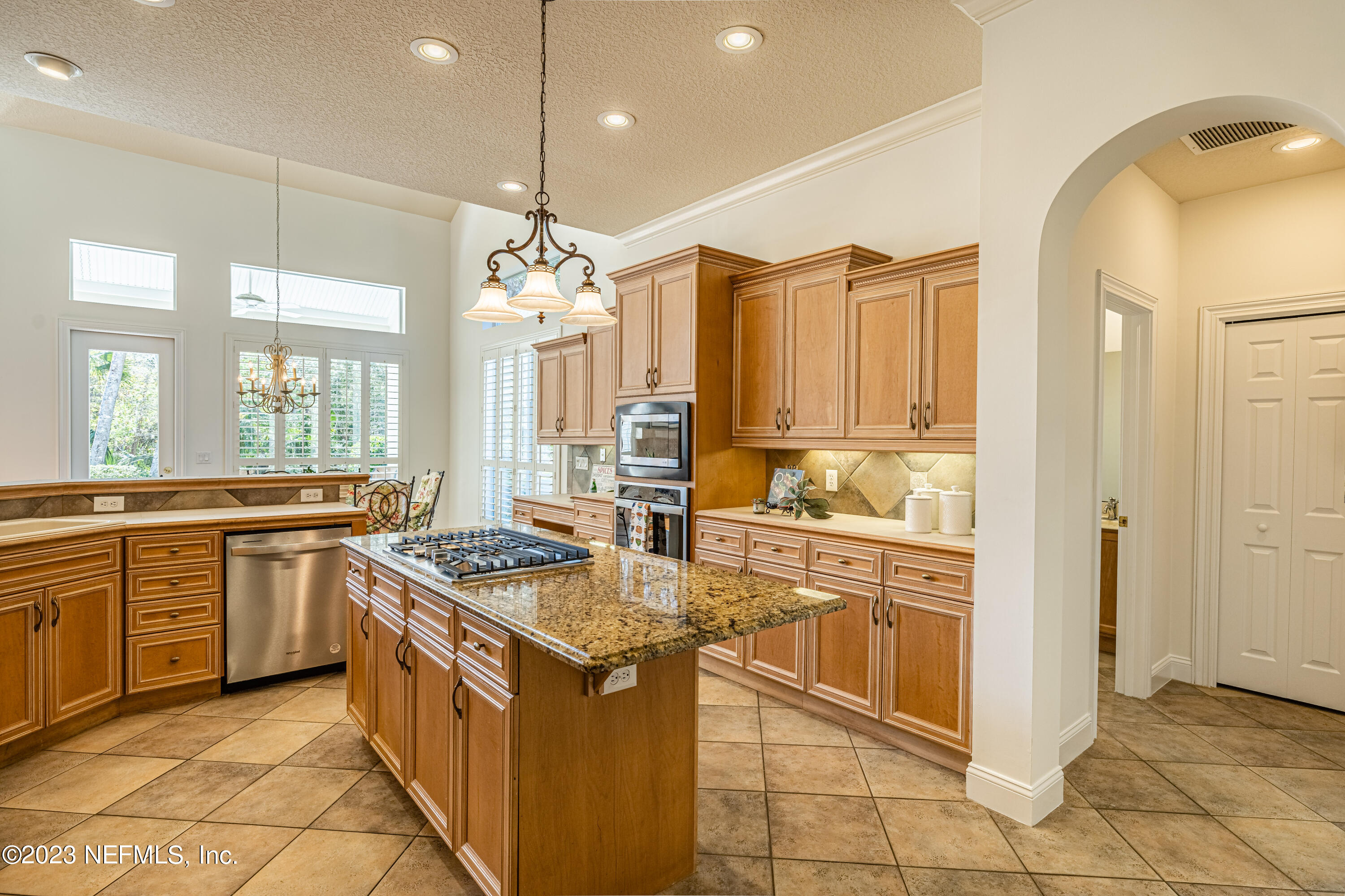 513 Fresh Pond Road Ponte Vedra Beach, FL 32082 - Photo 49 of 58 a kitchen with stainless steel appliances granite countertop a sink and a refrigerator