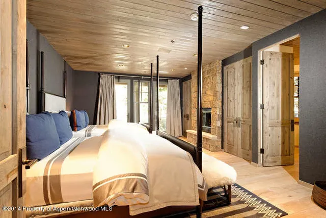 a spacious bedroom with a bed and a fireplace