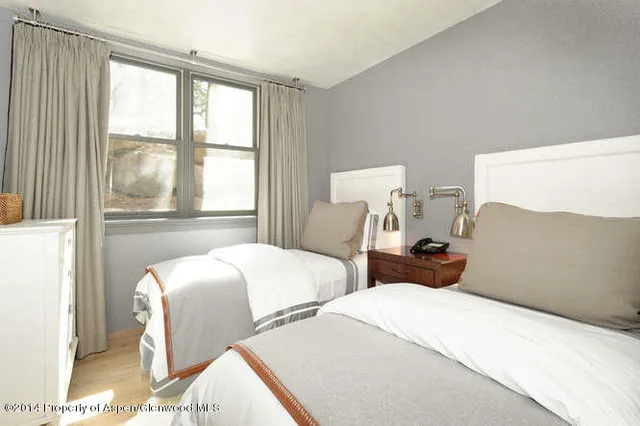 a bedroom with bed and a flat screen tv