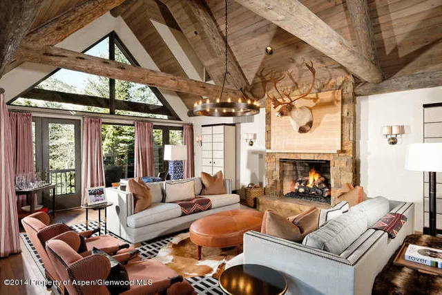 a living room with furniture a fireplace and a large window