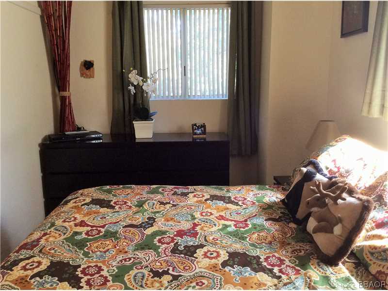 168 Riverside Avenue Sugarloaf, CA 92386 - Photo 11 of 23 a bedroom with a bed and a window