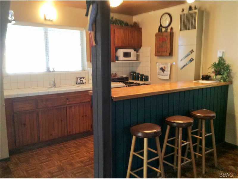 168 Riverside Avenue Sugarloaf, CA 92386 - Photo 18 of 23 a kitchen with a sink and a table