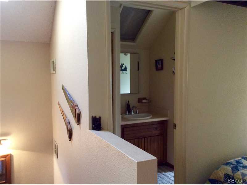 168 Riverside Avenue Sugarloaf, CA 92386 - Photo 23 of 23 a en suite bathroom with a sink a mirror and vanity
