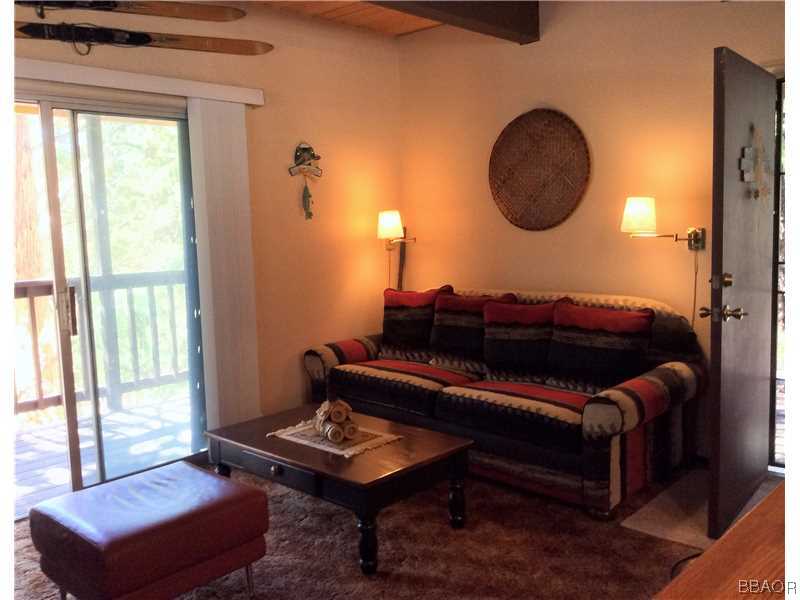 168 Riverside Avenue Sugarloaf, CA 92386 - Photo 8 of 23 a living room with furniture a rug and a window