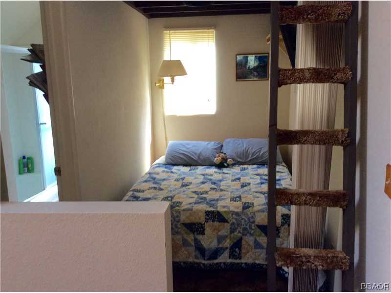 168 Riverside Avenue Sugarloaf, CA 92386 - Photo 9 of 23 a bedroom with a bed and a window