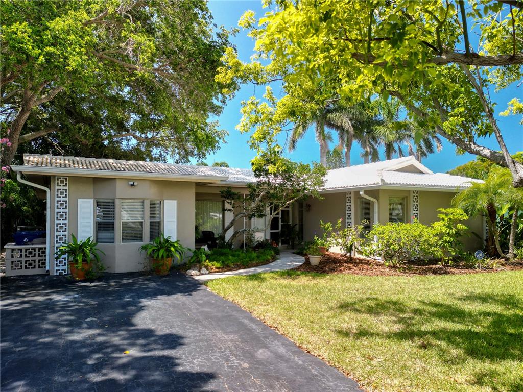 11030 Navajo Drive St. Petersburg, FL 33708 - Photo 1 of 1 a front view of a house with garden